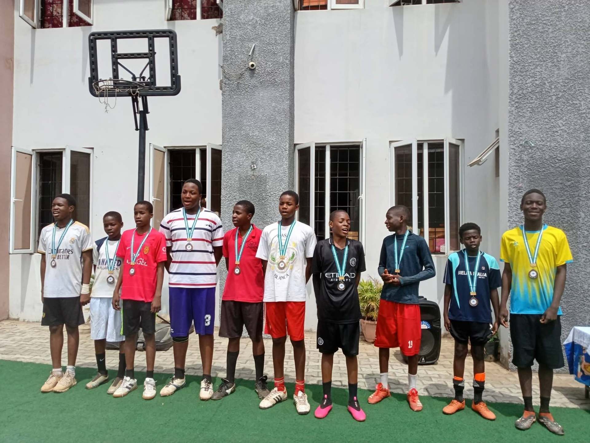 Chalcedony students receiving sports medals at the school field